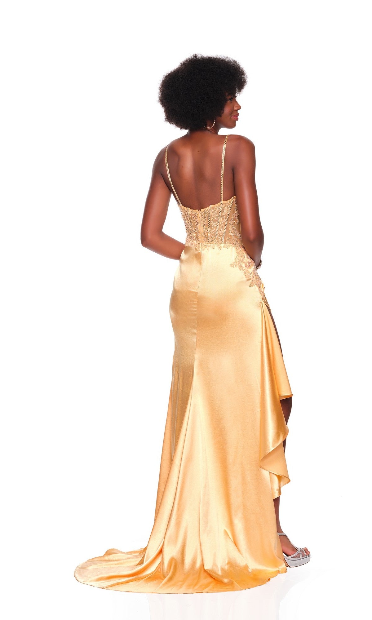 A woman faces away from the camera in the Dave and Johnny 12807 long prom dress, featuring a satin skirt, thin straps, lace-detailed corset bodice, and a train.